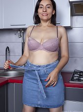 Allegra poses naked in her kitchen
